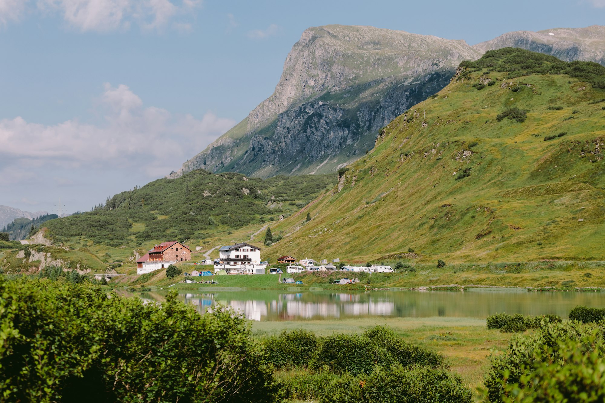 beautiful mountain village with lake and green hills